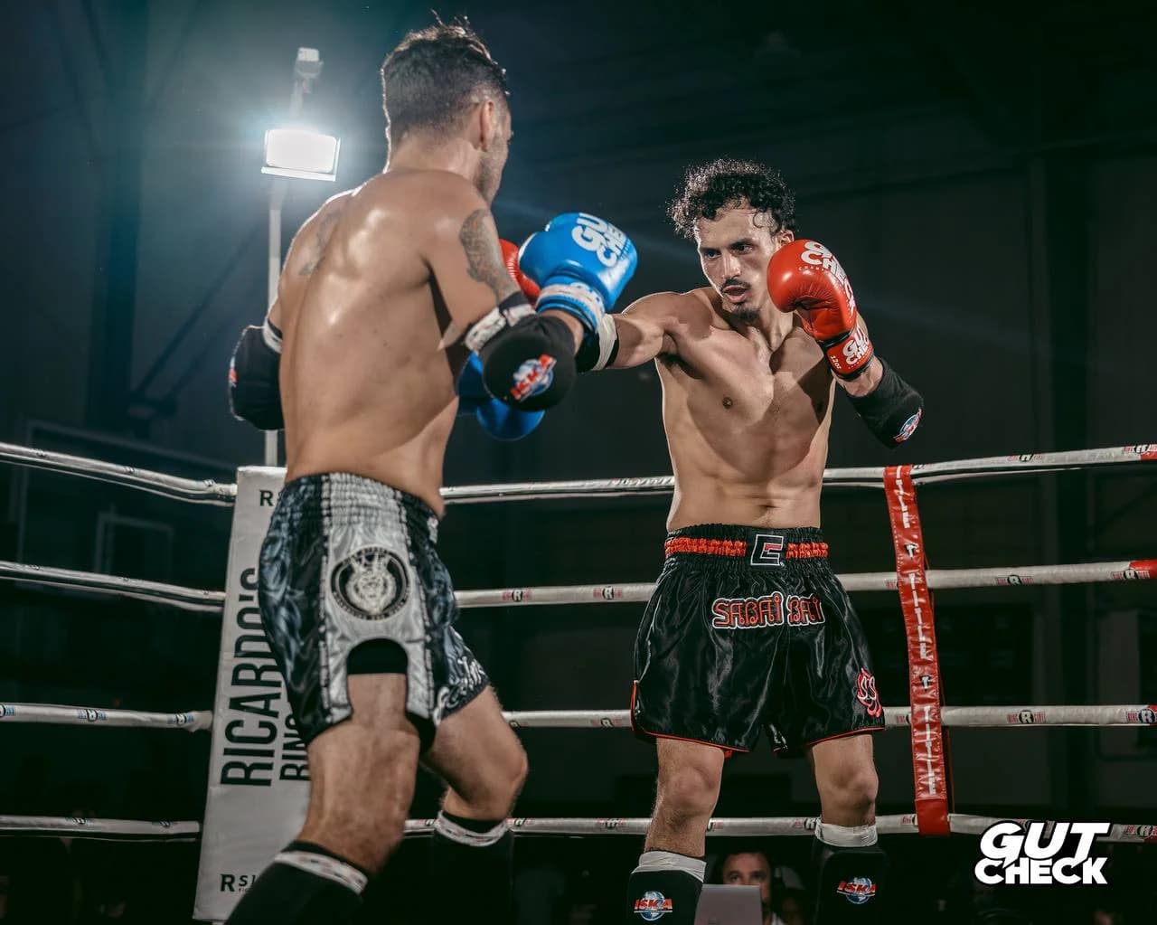 Two skilled Muay Thai fighters exchange blows in the ring at Gut Check Championship Series, the top Muay Thai competition near Philadelphia.